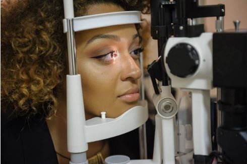 Eye Exams — Woman Having Her Eye Exam in Sunrise, FL