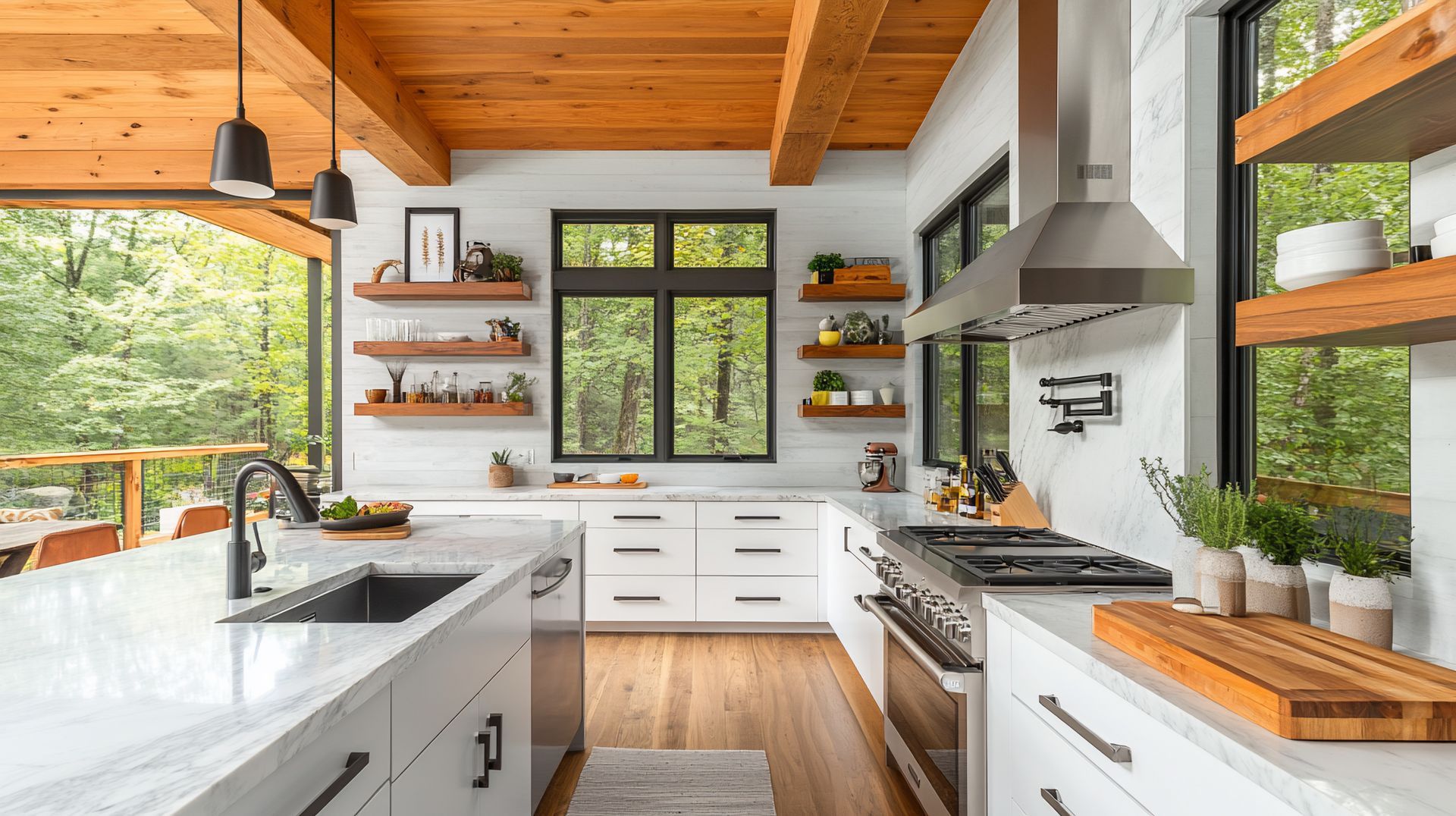 Bright modern kitchen with white cabinets, wood countertops, stainless range hood, and large window views