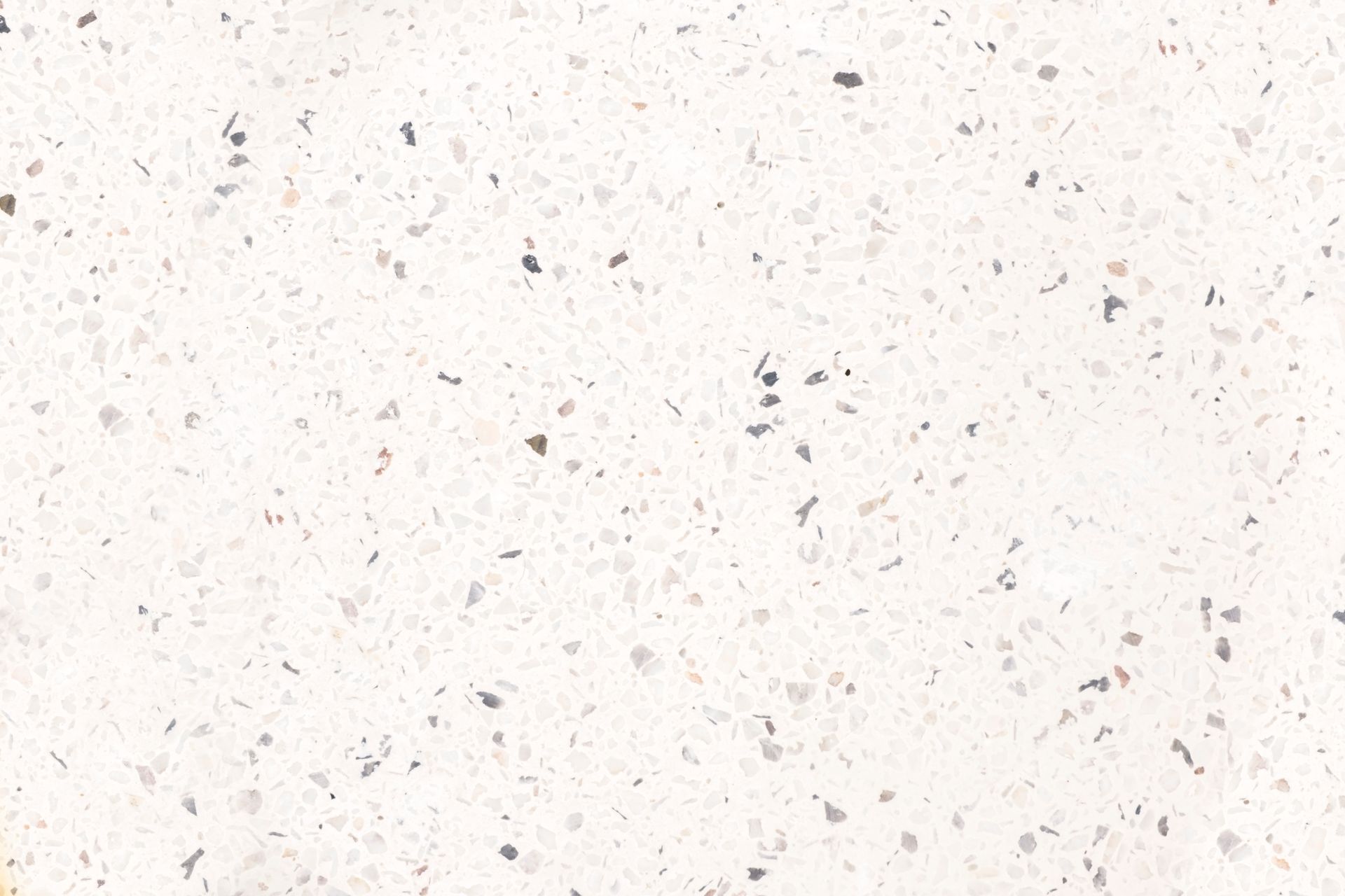 White textured surface with scattered gray specks and faint scratches