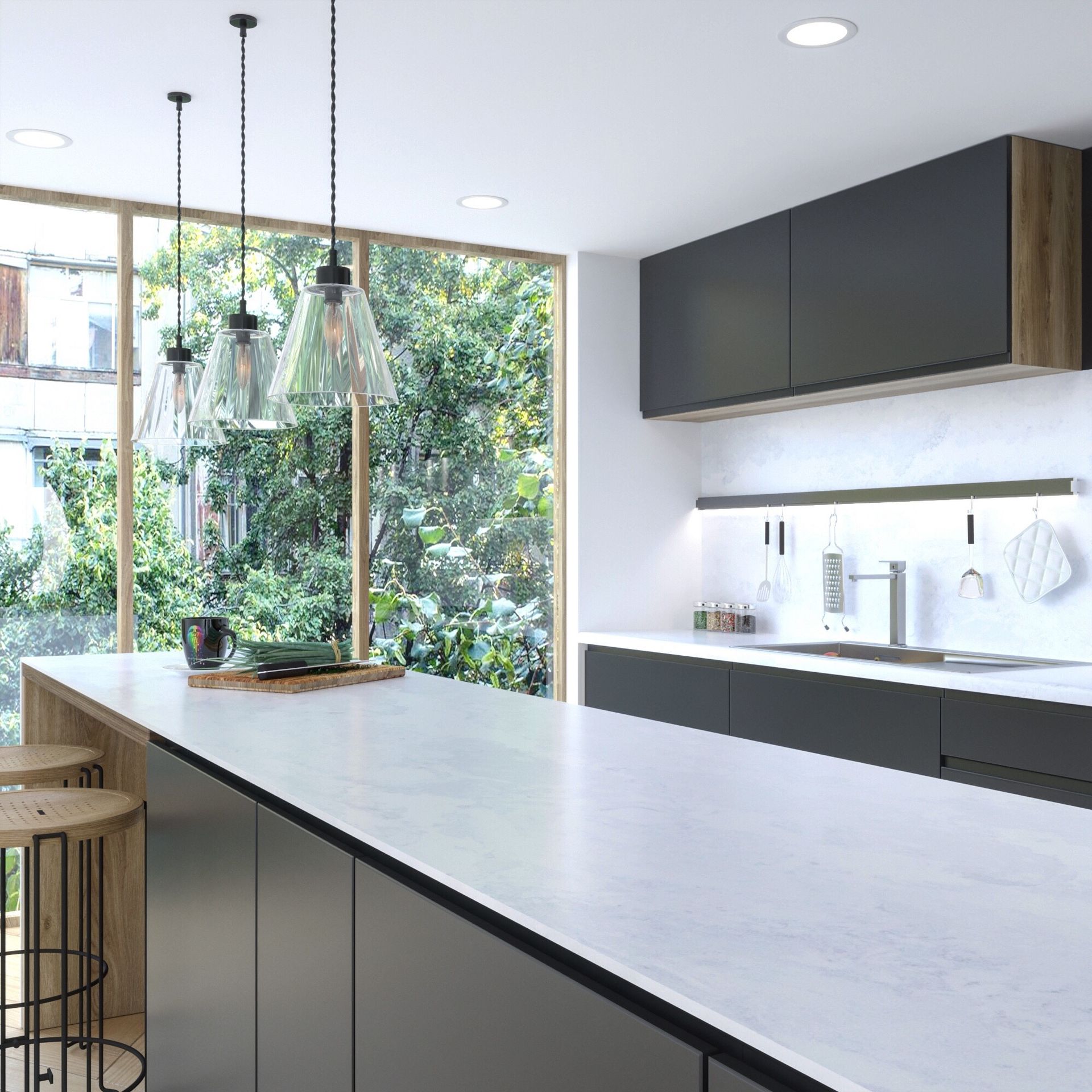 Modern kitchen with dark cabinets, white island, and large windows overlooking greenery