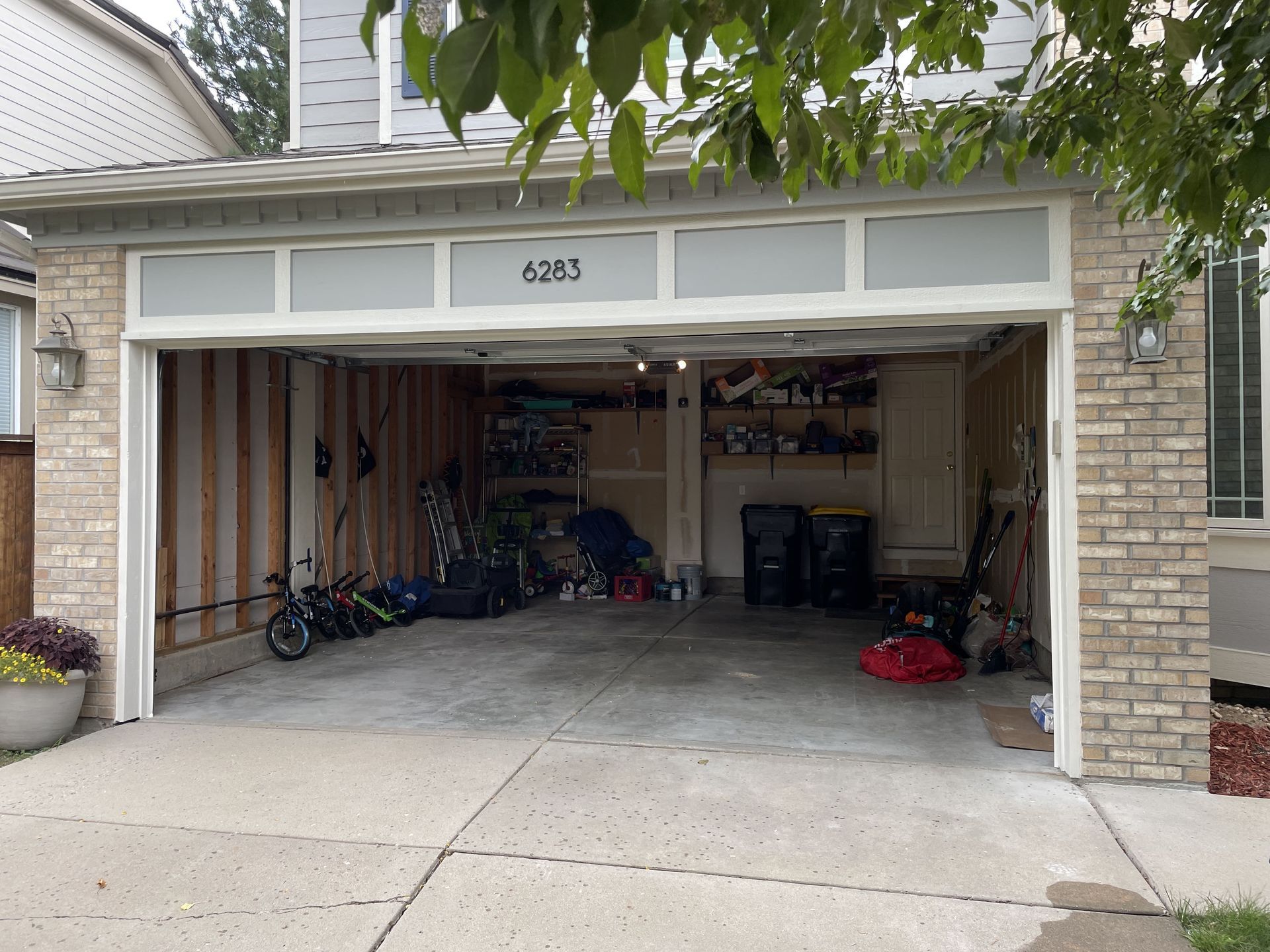 Open garage with clutter inside, displaying various ite