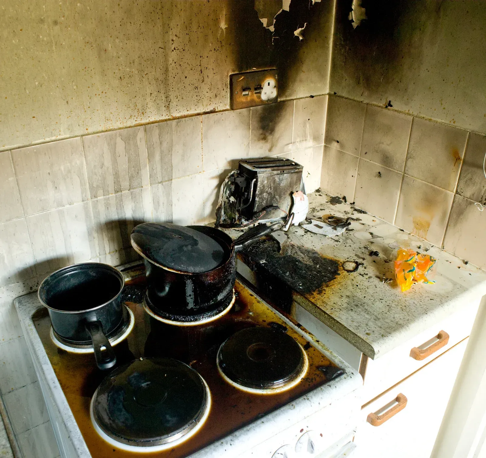 Interior of a room severely damaged by fire. Walls are charre
