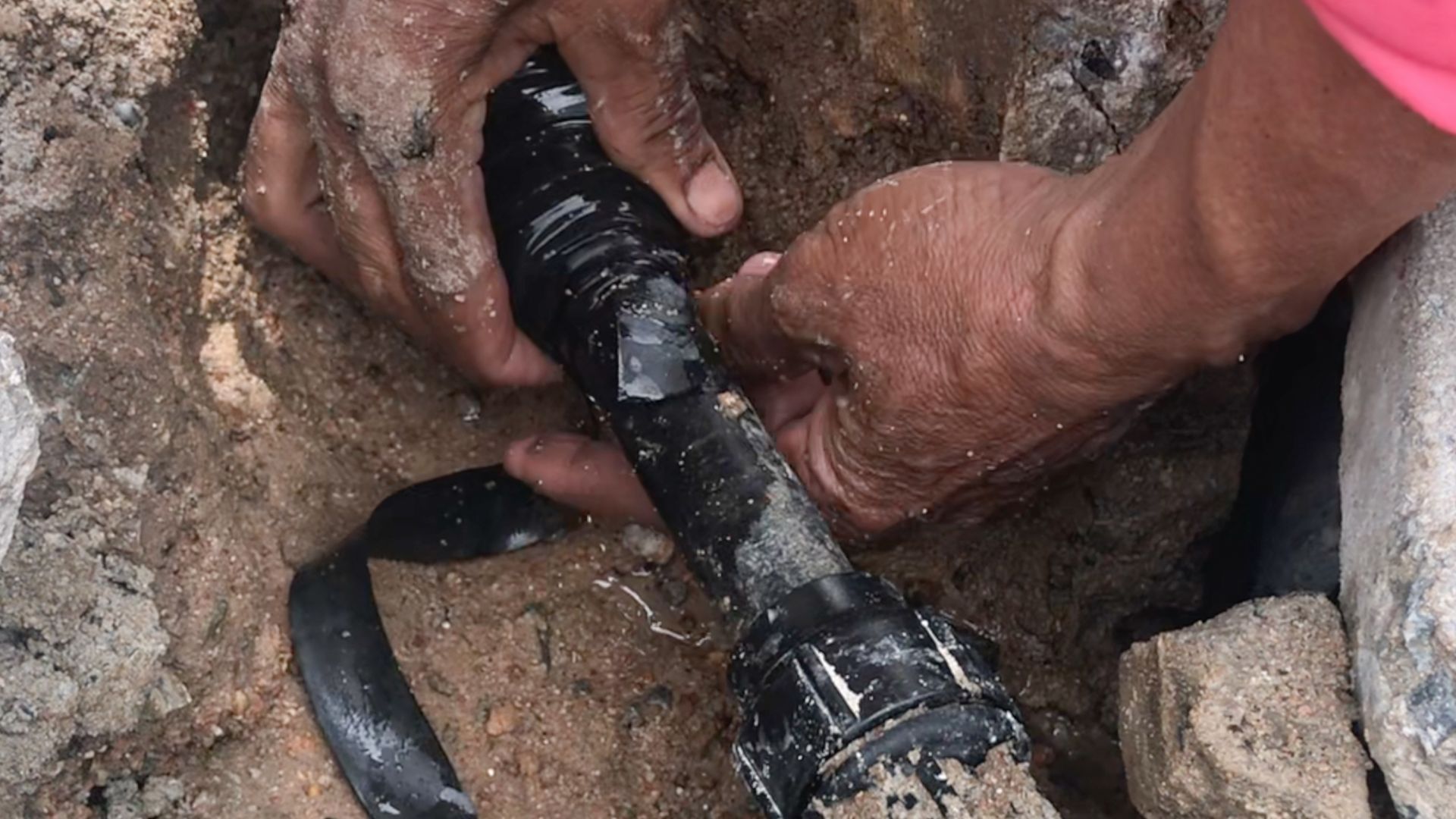 A plumber is repairing a broken pipe.
