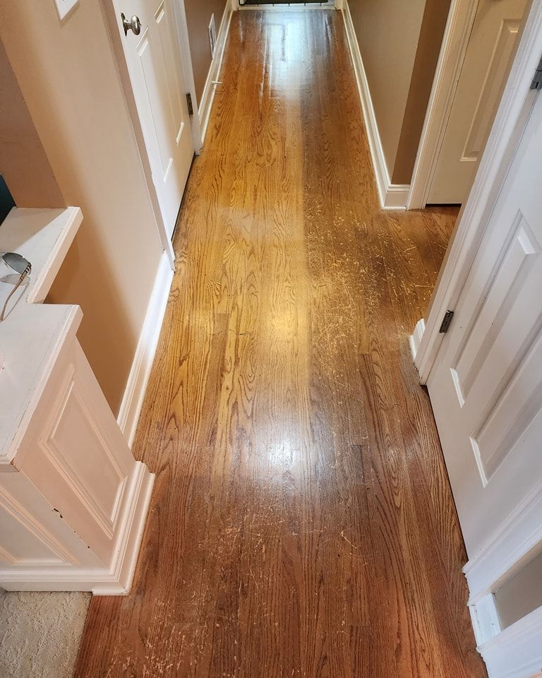 Strongarm Cleaners - A hallway with hardwood floors and white doors