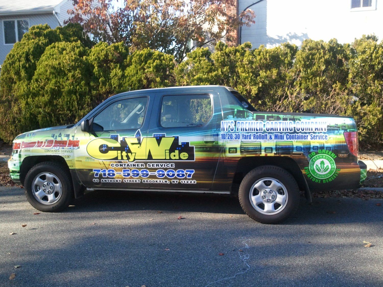 A citywide truck is parked on the side of the road