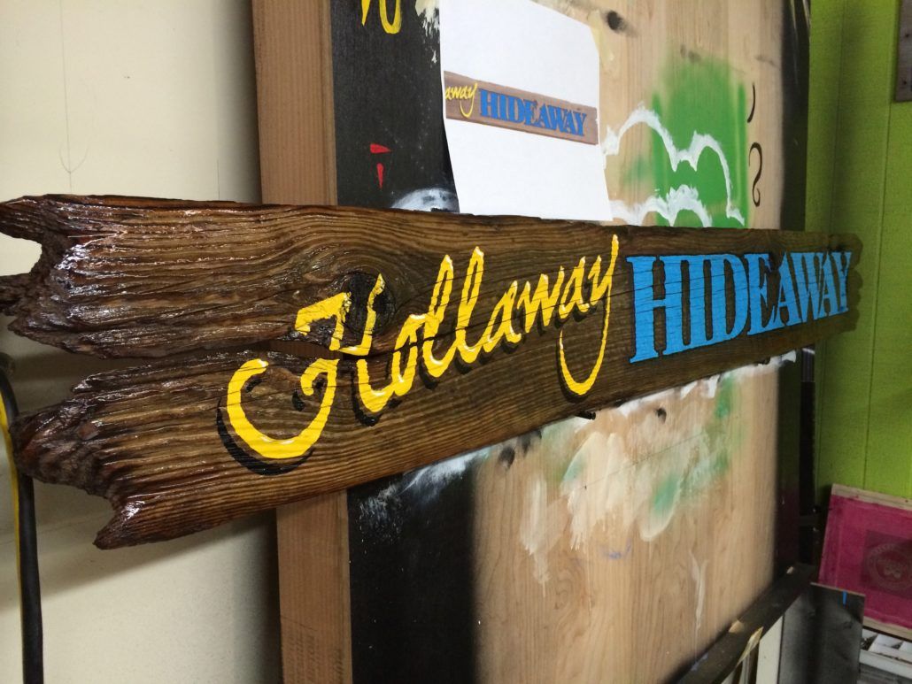 A wooden sign that says hillway hideaway on it
