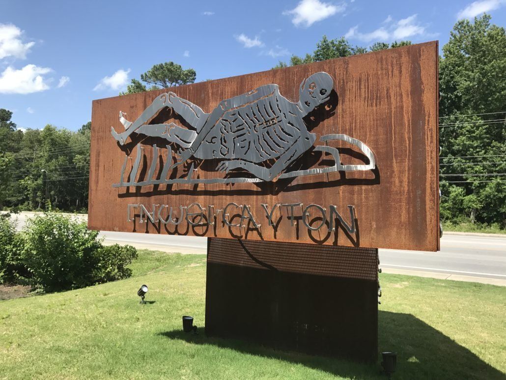 A large rusty sign that says ' fnuer dayton ' on it