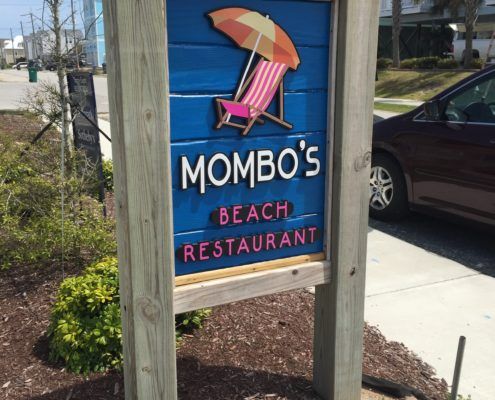 A blue sign for mombo 's beach restaurant
