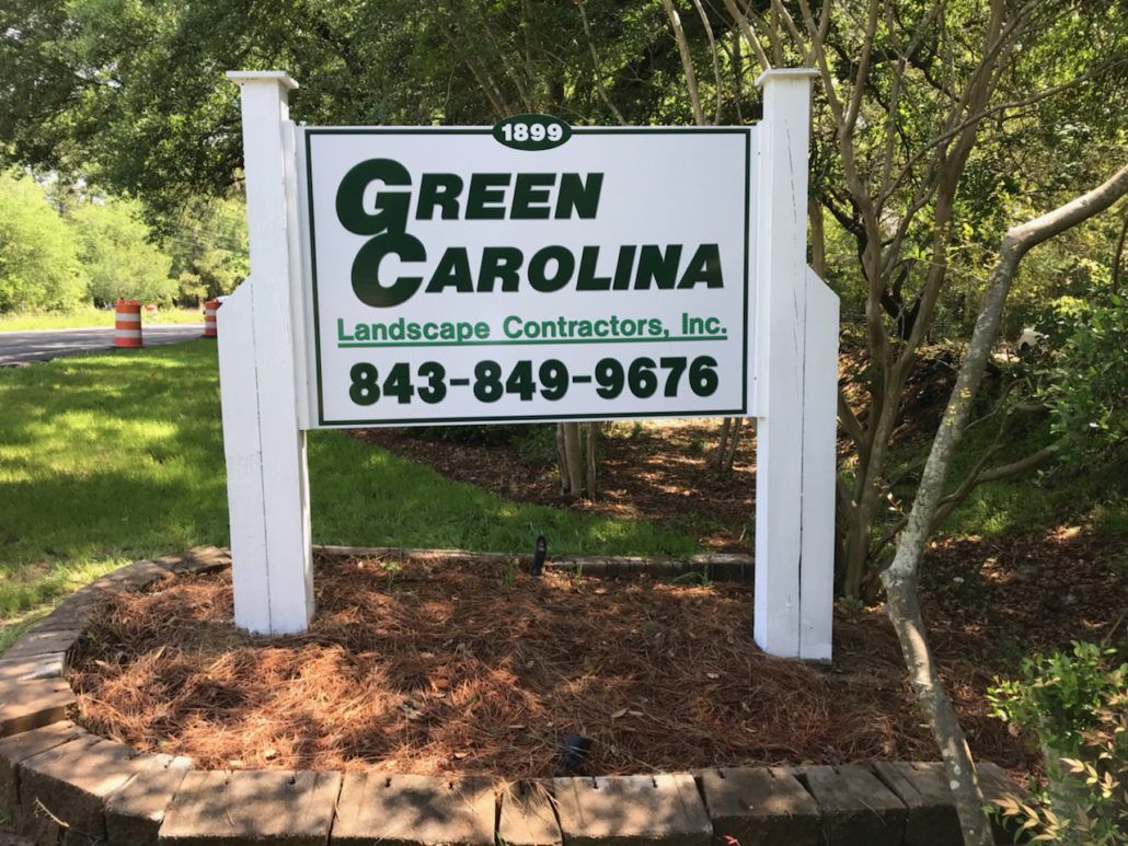 A sign for green carolina landscaping contractors inc.