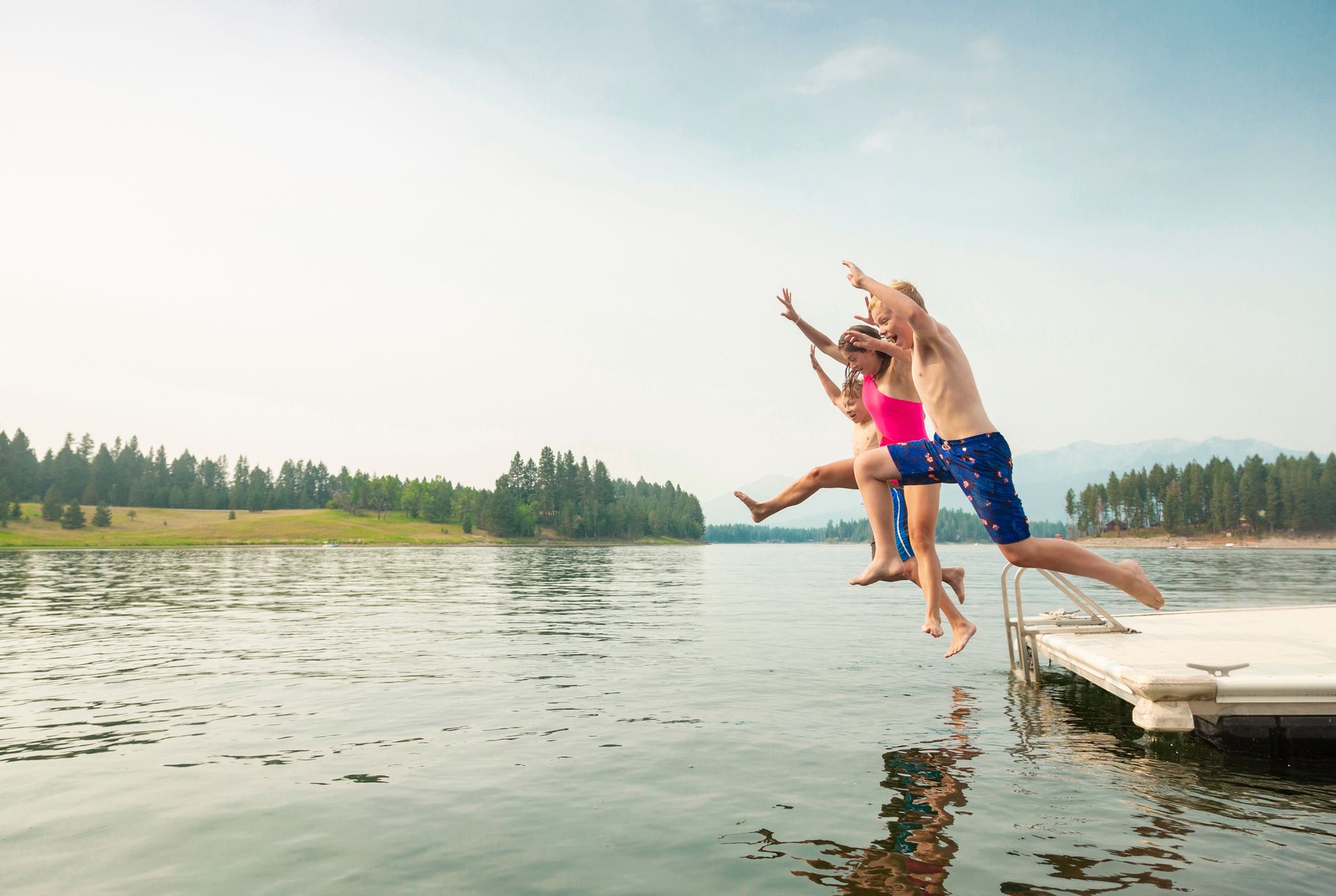 Kids jumping into water