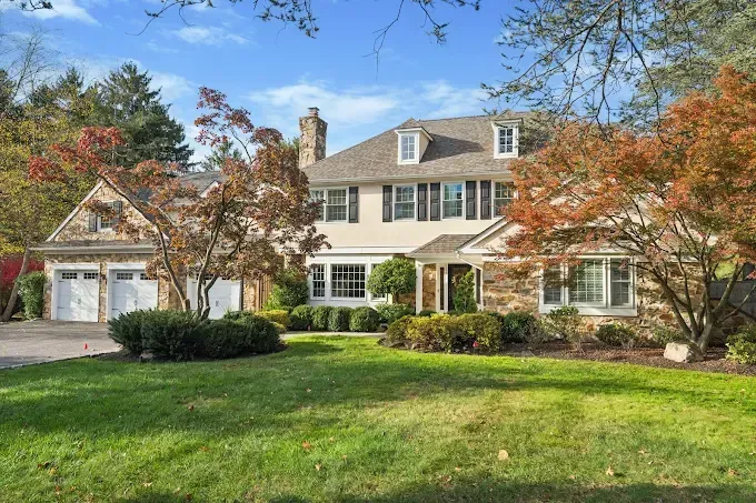 A large house with a large lawn in front of it.