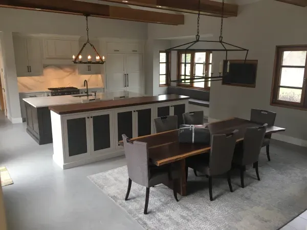 A kitchen and dining room with a wooden table and chairs