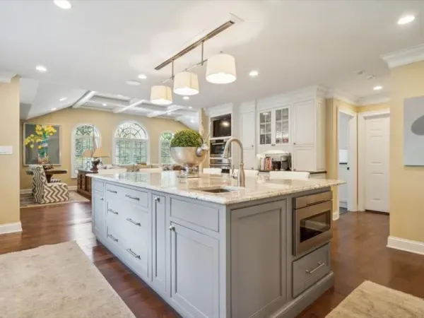 A kitchen with a large island and a sink