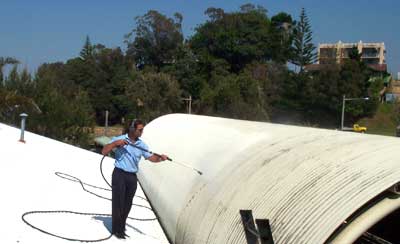 A Commercial Roof Being Power Washed — Pressure Cleaning in Nambucca Valley, NSW