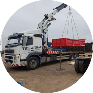 lorry crane moving  a small red container