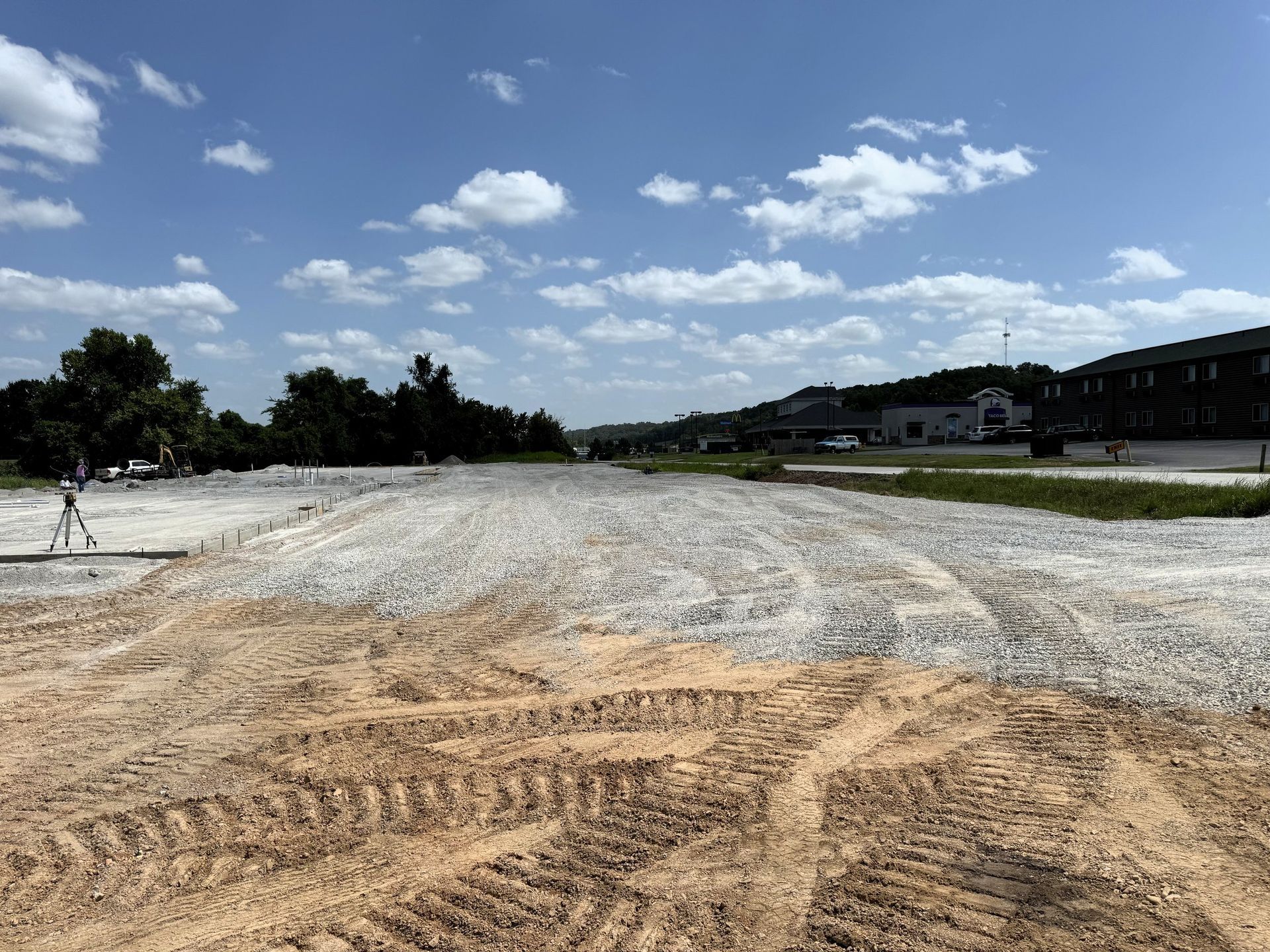 A construction site with a gravel base under a blue sky.