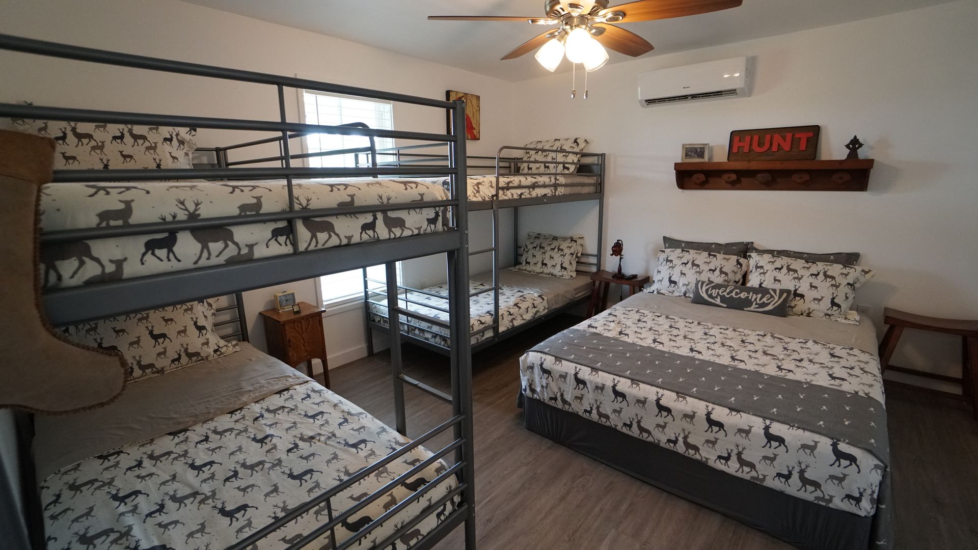 Bedroom with bunk beds, double bed, deer-patterned bedding, and a 