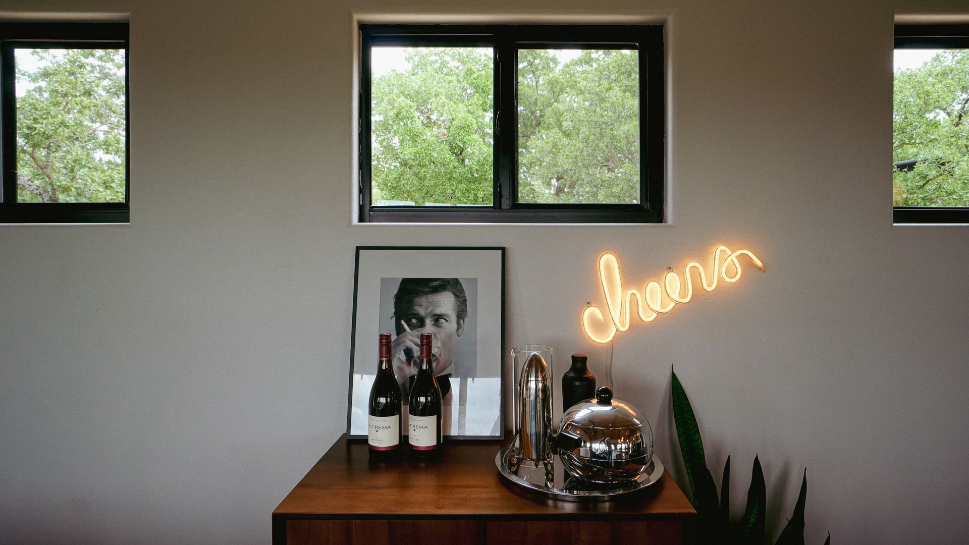 Wooden cabinet with bottles, artwork, and 