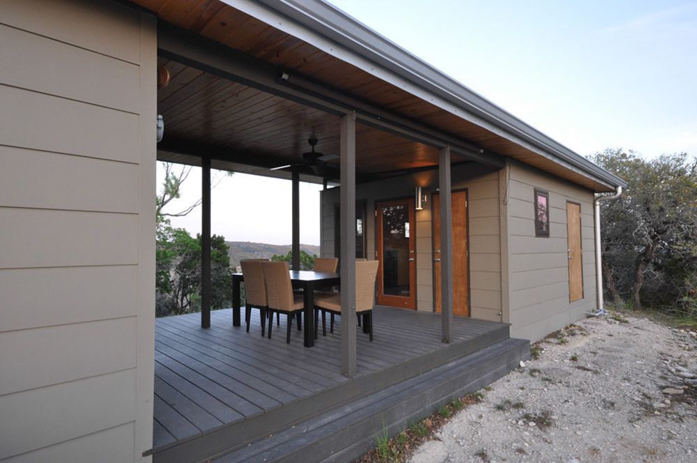 A house with a porch with a table and chairs on it