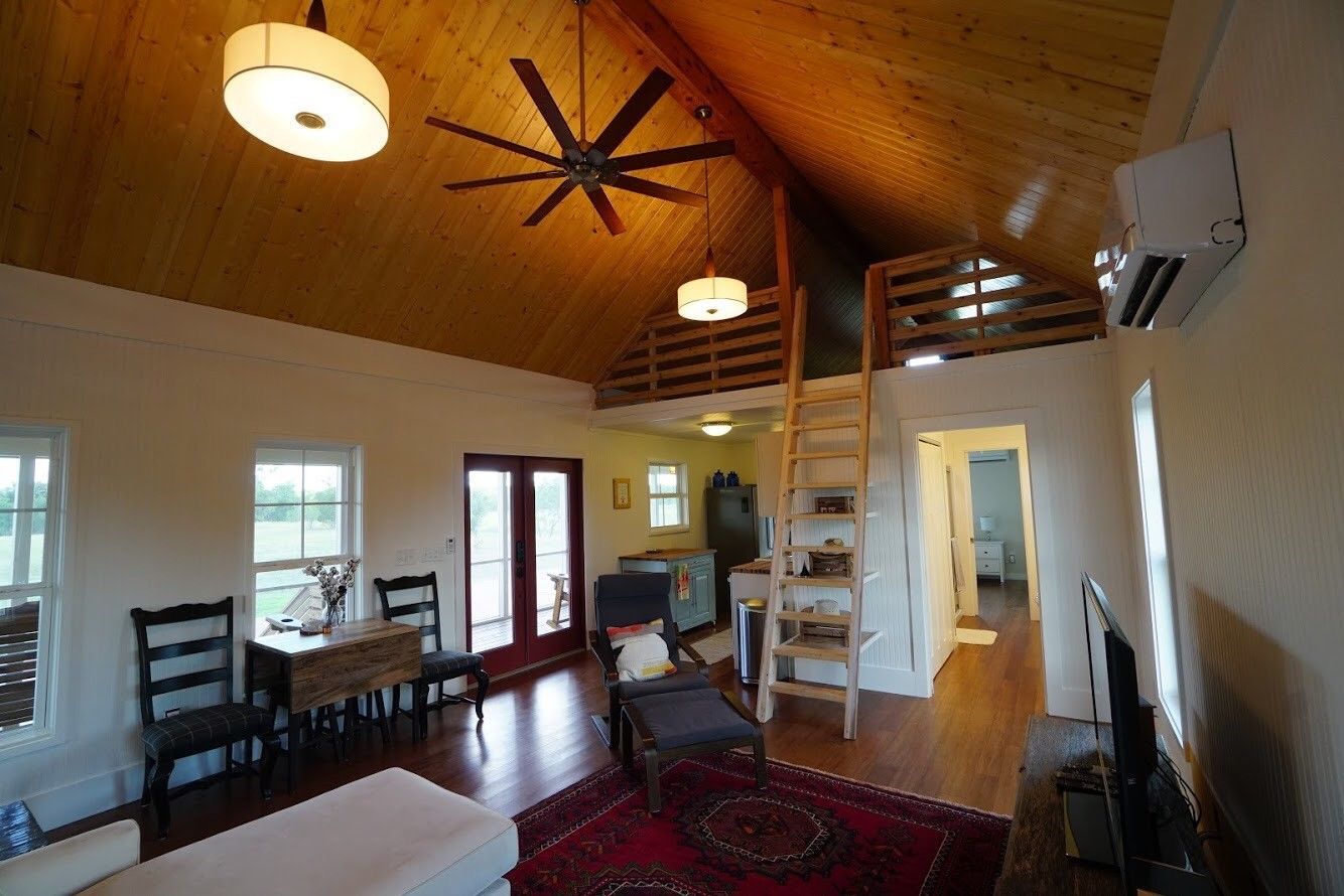 A living room with a staircase leading to the second floor