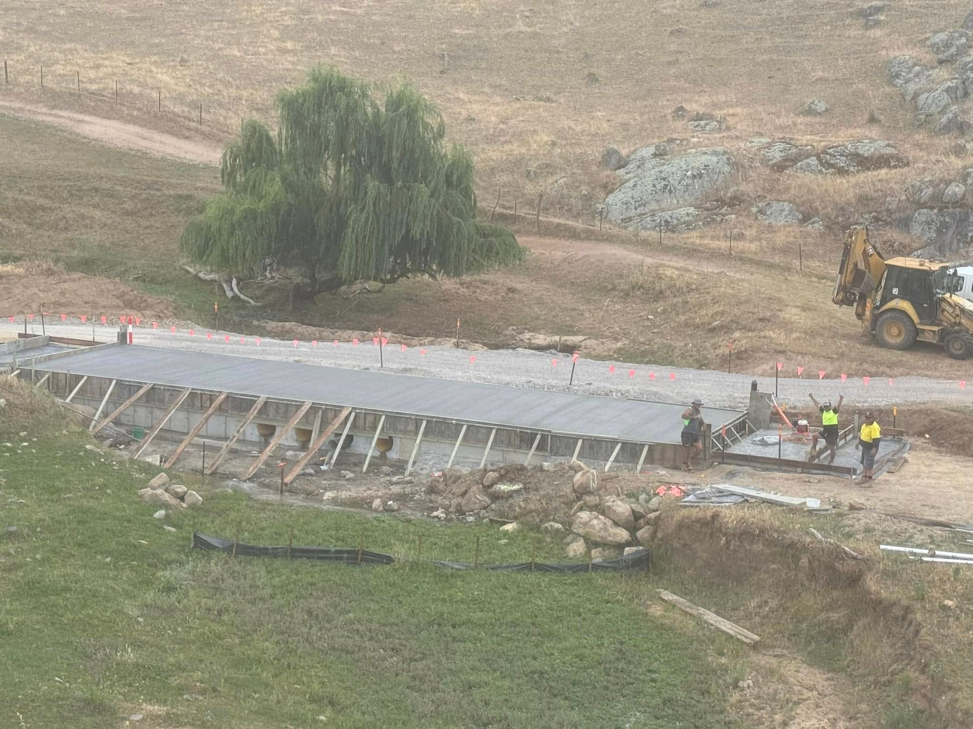 A Group of Construction Workers Are Pouring Concrete on A Sidewalk — Next Level Construction Contractors in Gundagai, NSW