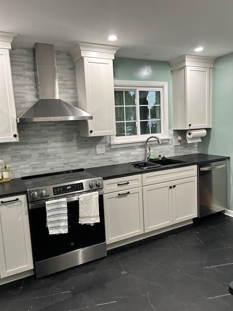 A Kitchen with White Cabinets and Stainless Steel Appliances.