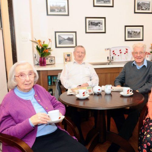senior citizen having tea together
