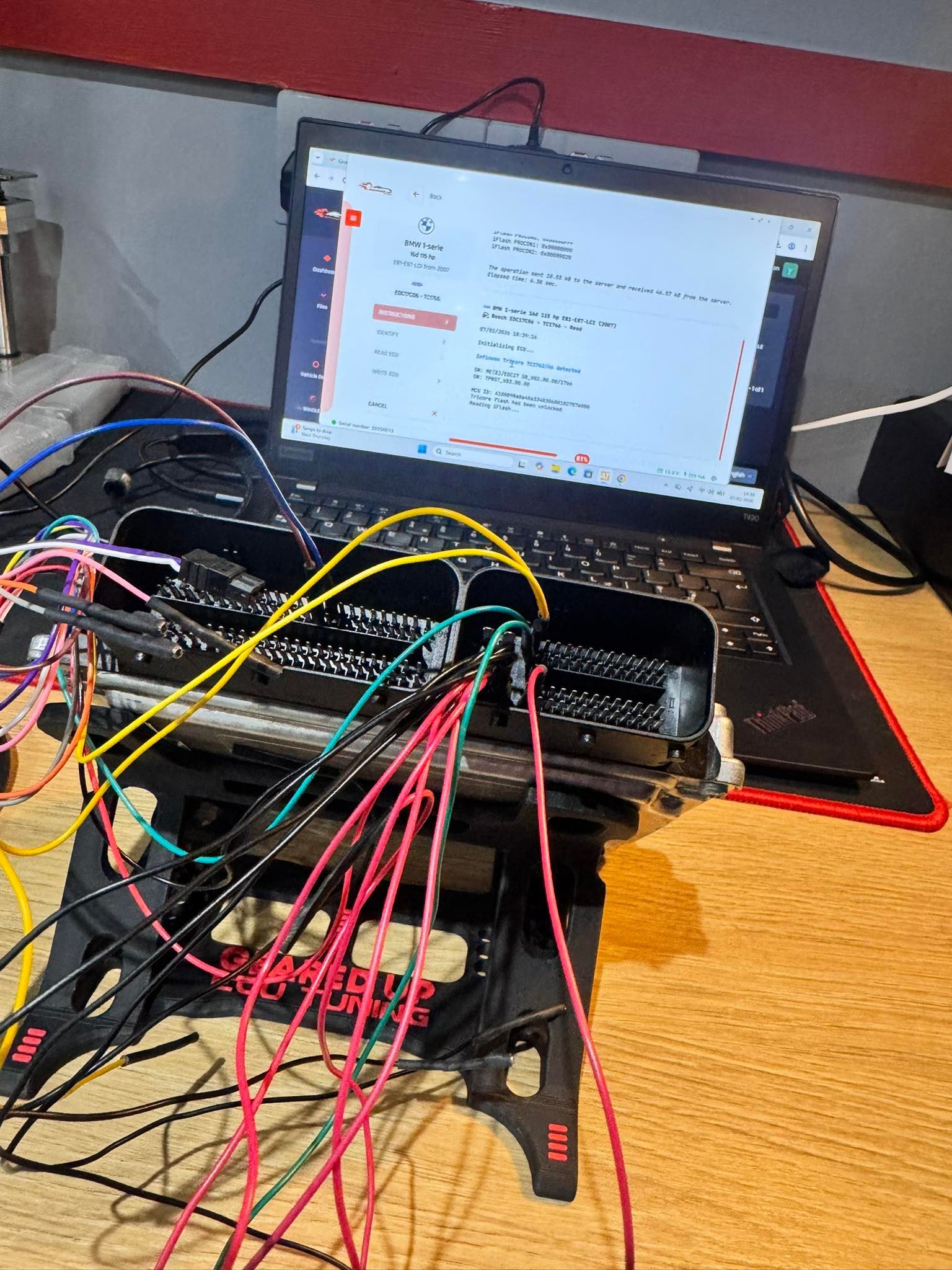 Laptop on desk with a web page open, connected to a breadboard and many colorful jumper wires
