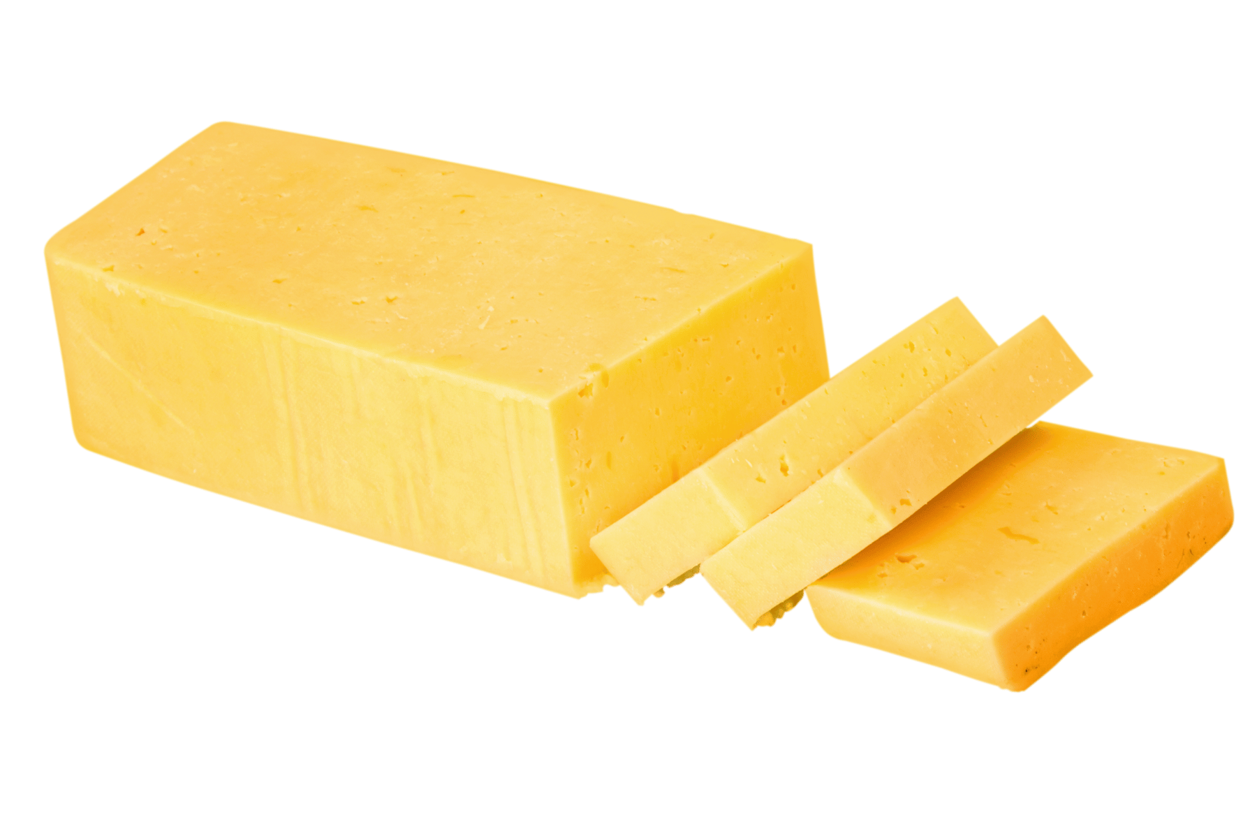 A block of cheddar cheese is cut into slices on a white background