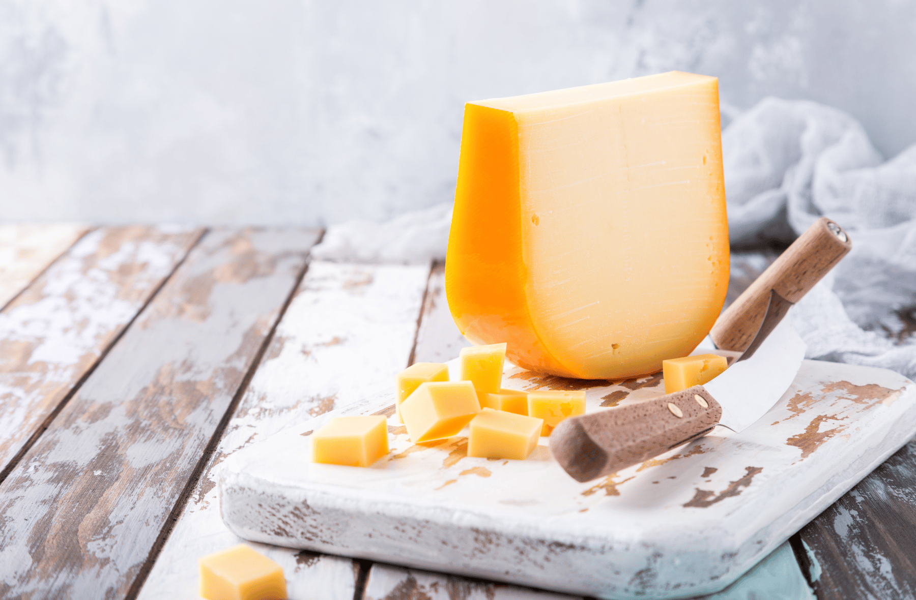 Hard Cheese on a plate with knives