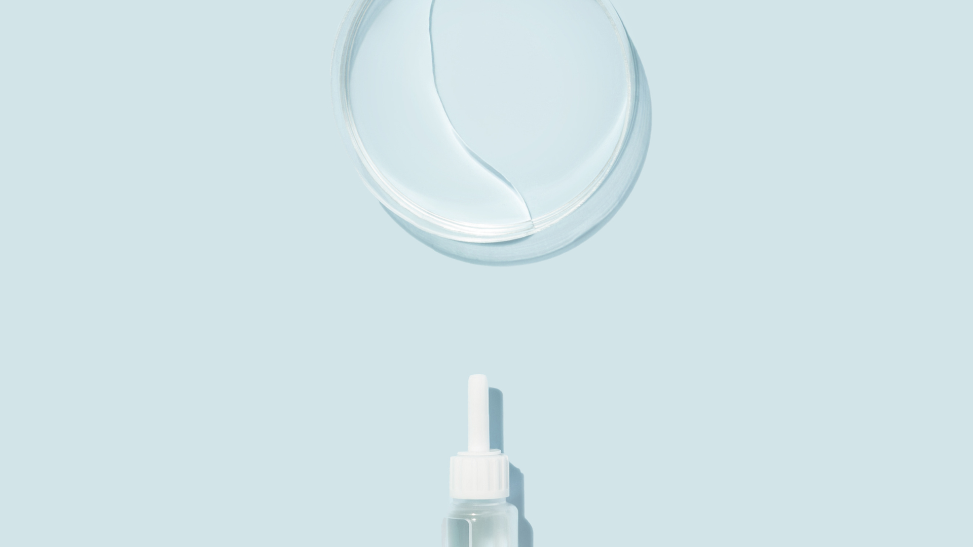 Woman in bed, holding phone, with hand on forehead, looking stressed.