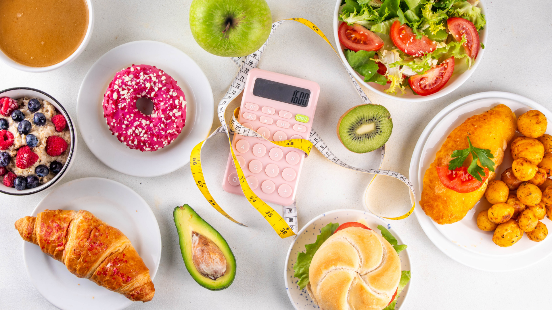 A flat-lay view of assorted foods, including a salad, donut, avocado, and chicken, with a calculator and measuring tape.