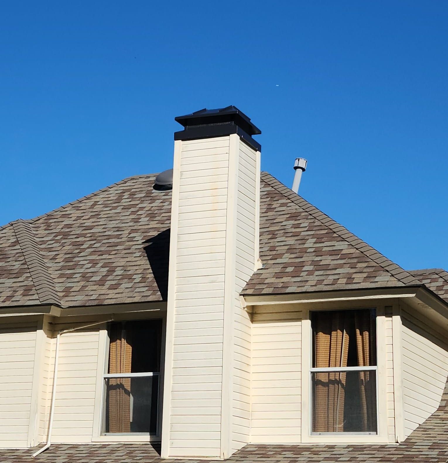 A house with a chimney on top of it