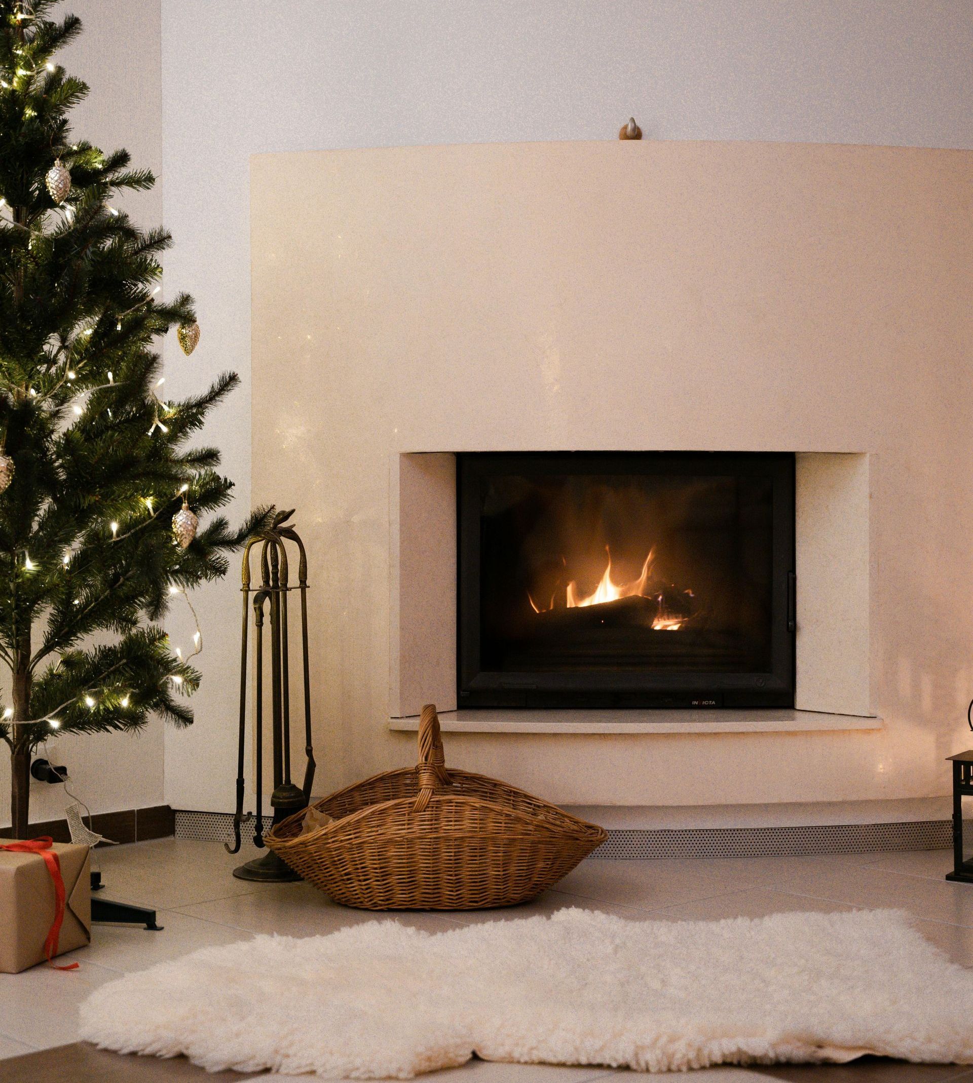 A living room with a fireplace and a christmas tree