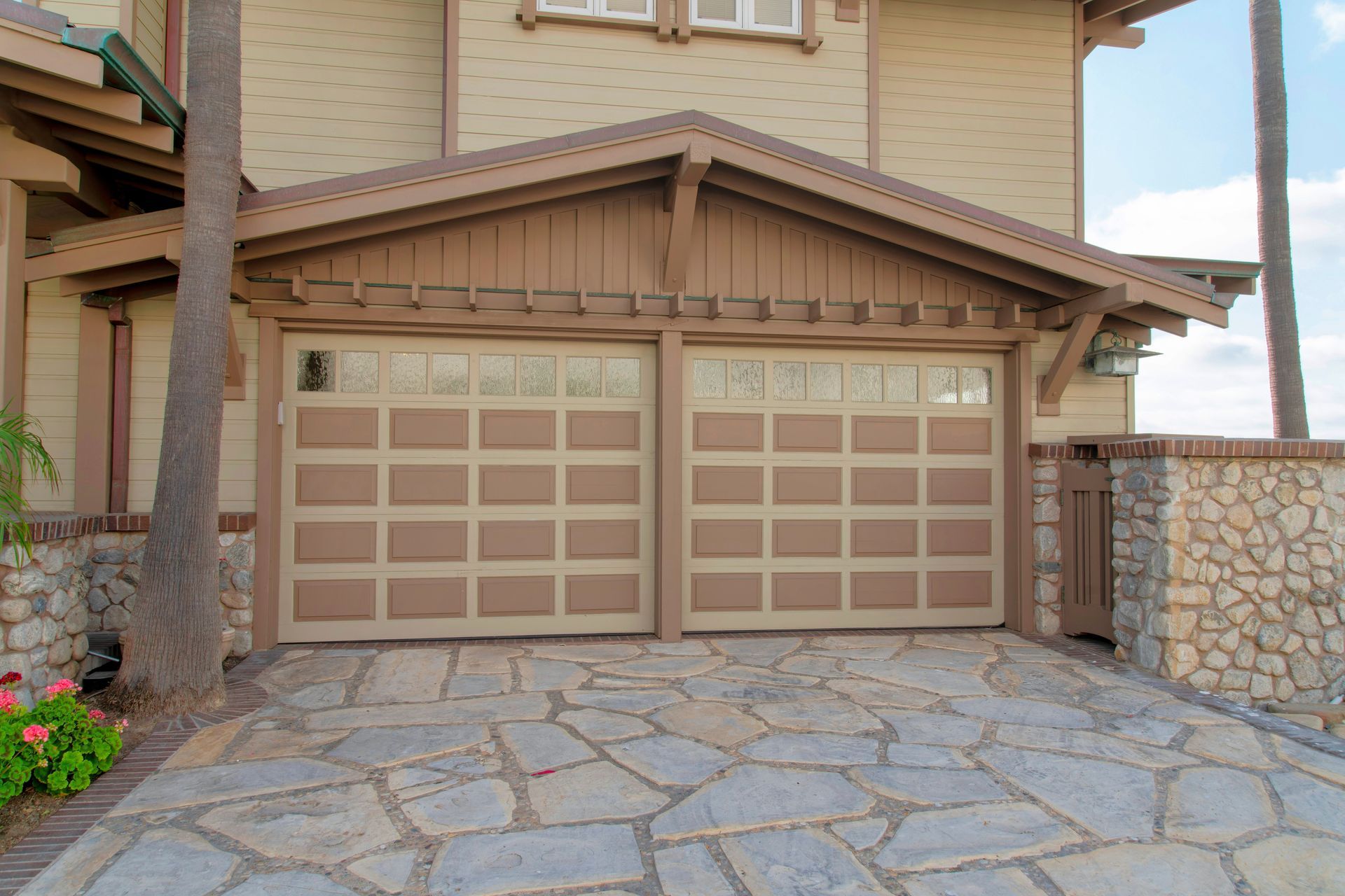 Attached garage exterior with vinyl lap and stone veneer sidings