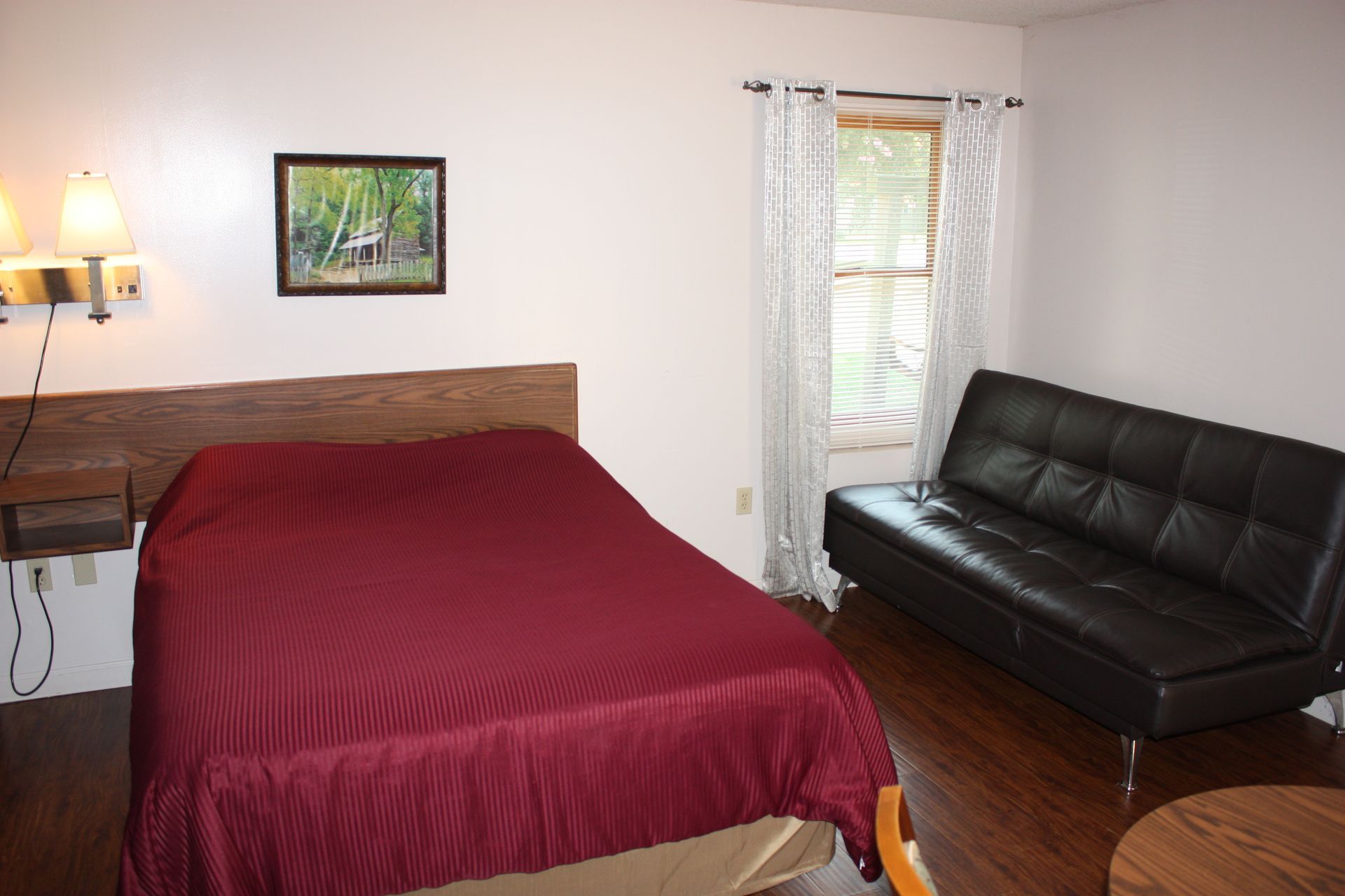 There is a bed and a couch in the room.