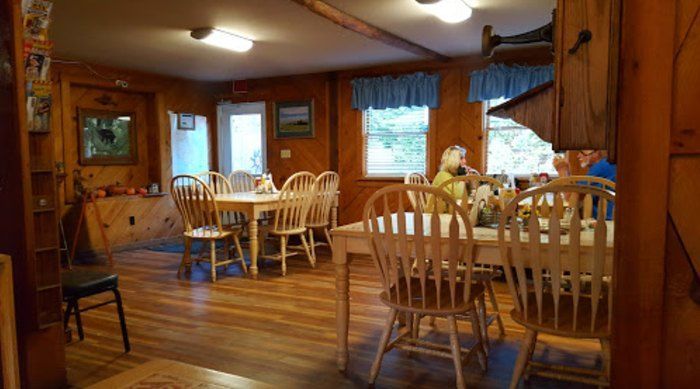 There are many tables and chairs in the room.