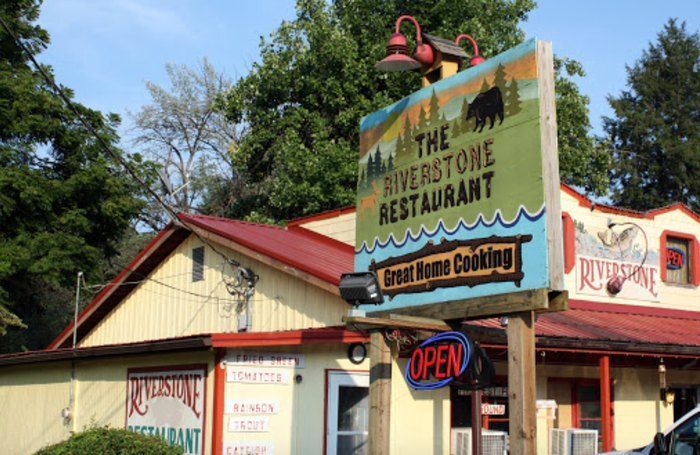 A restaurant with a sign that says the riverstone restaurant