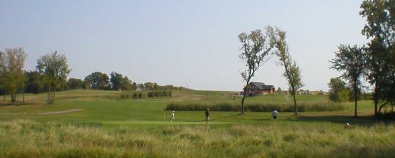 A golf course with a house in the background