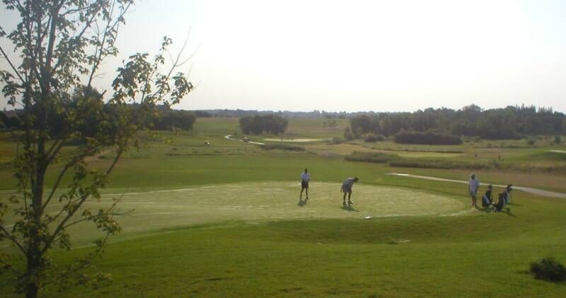 A group of people are playing golf on a golf course