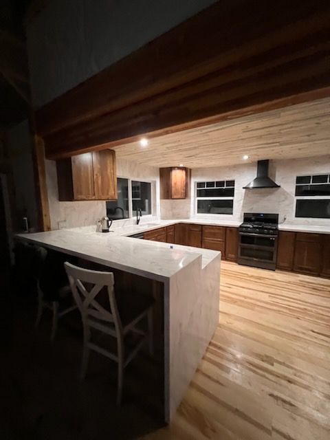 A kitchen with wooden cabinets and a white counter top