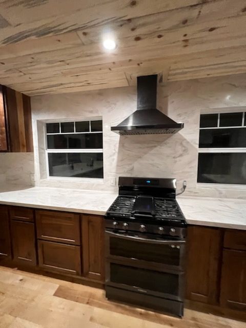 A kitchen with stainless steel appliances and wooden cabinets.