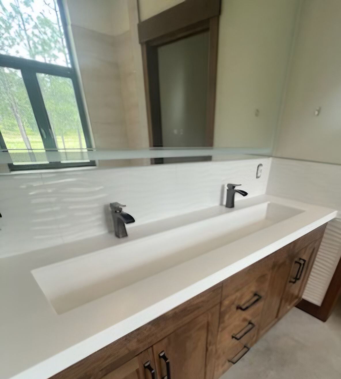 A bathroom with two sinks and a mirror