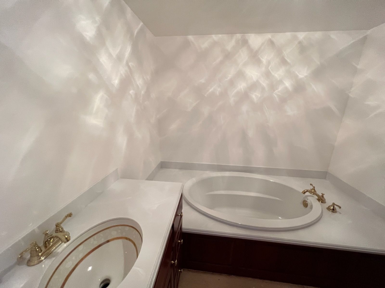 A bathroom with a sink and a jacuzzi tub