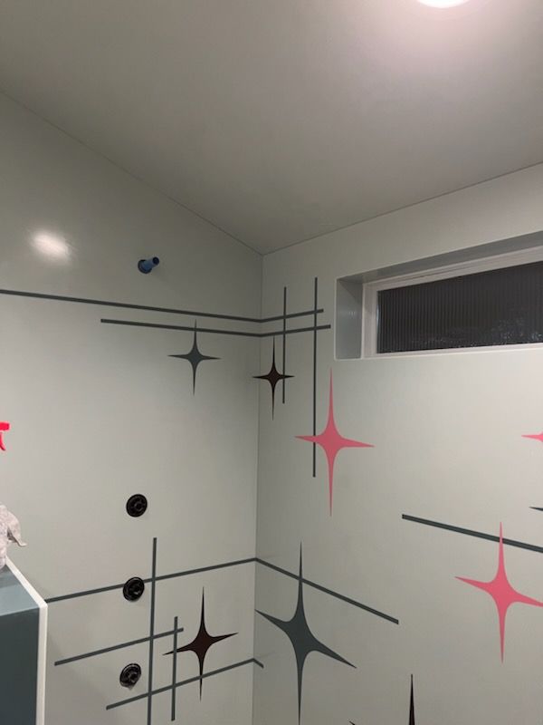 A white wall with pink stars painted on it