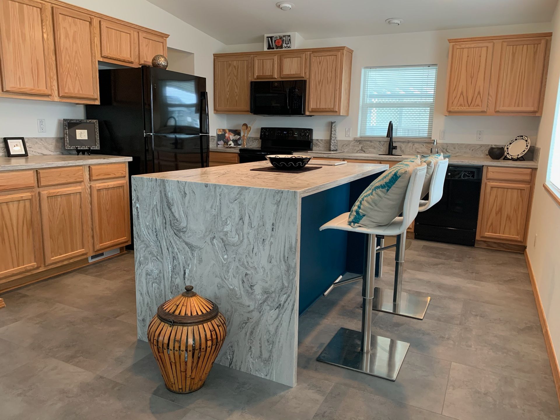 A kitchen with a large island in the middle of the room.