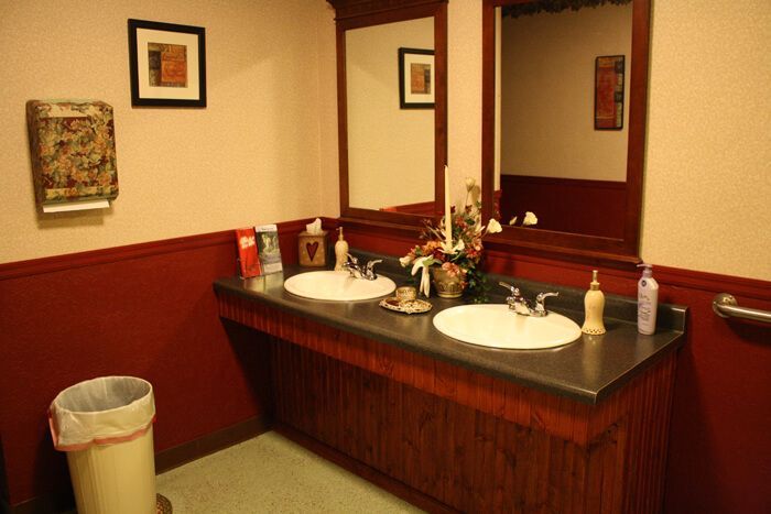 a bathroom with two sinks and two mirrors