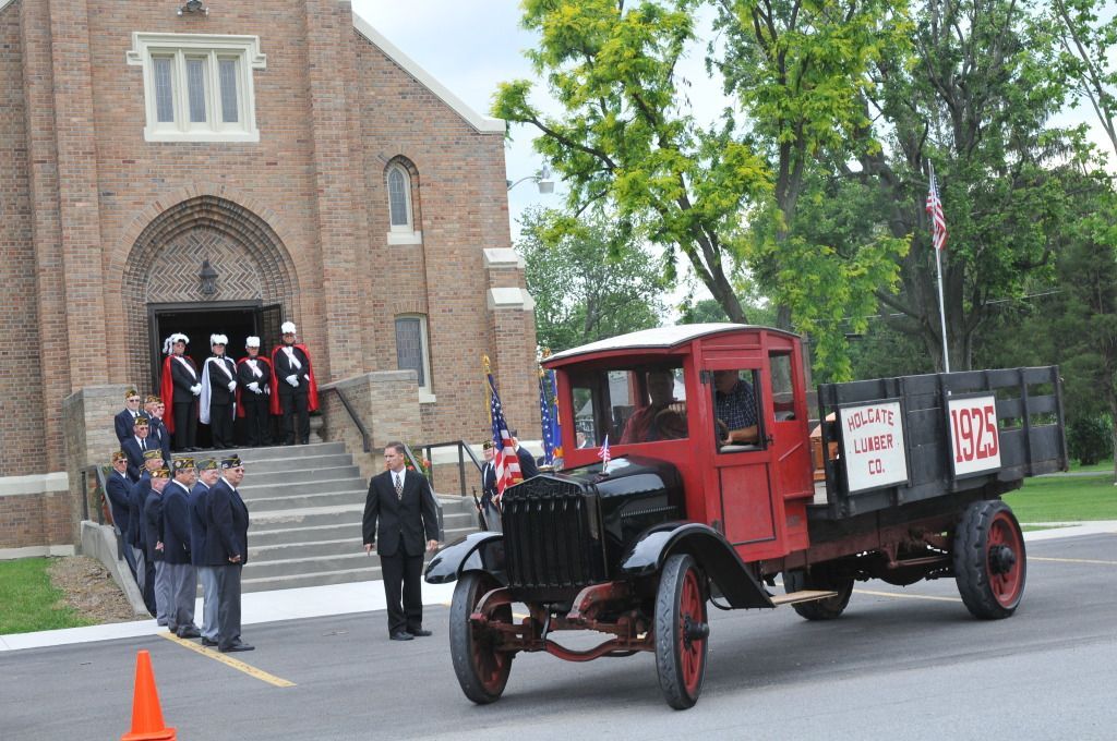 two men are riding in a horse drawn carriage