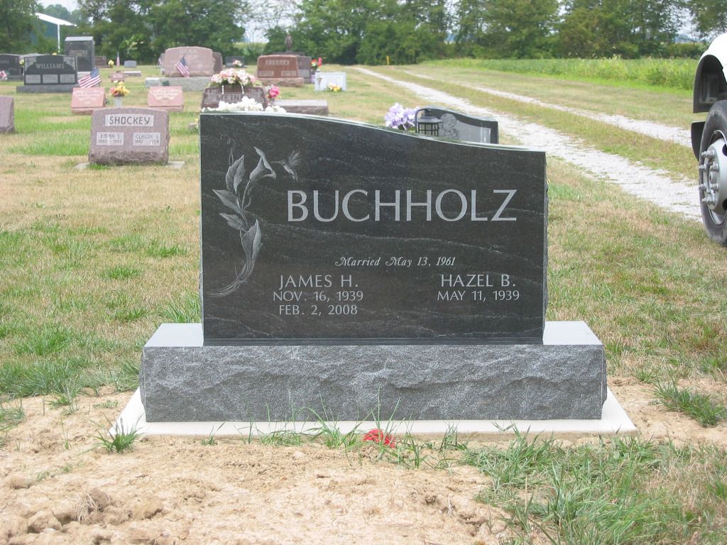 a gravestone for buchholz is in a cemetery