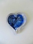 a heart shaped ashtray with a blue heart in it .